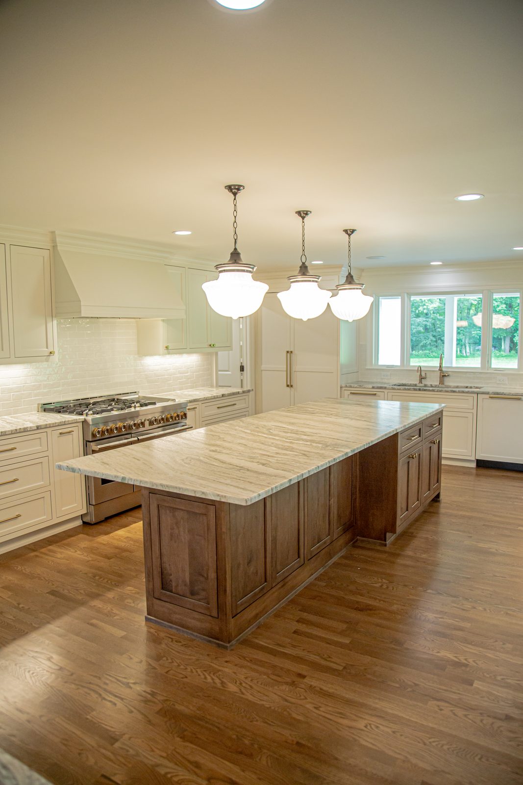 Traditional kitchen with wood island and marble counters