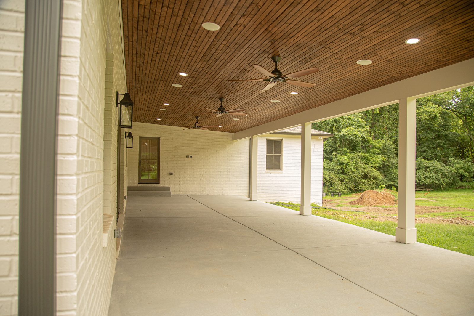 Covered porch addition with wood ceiling