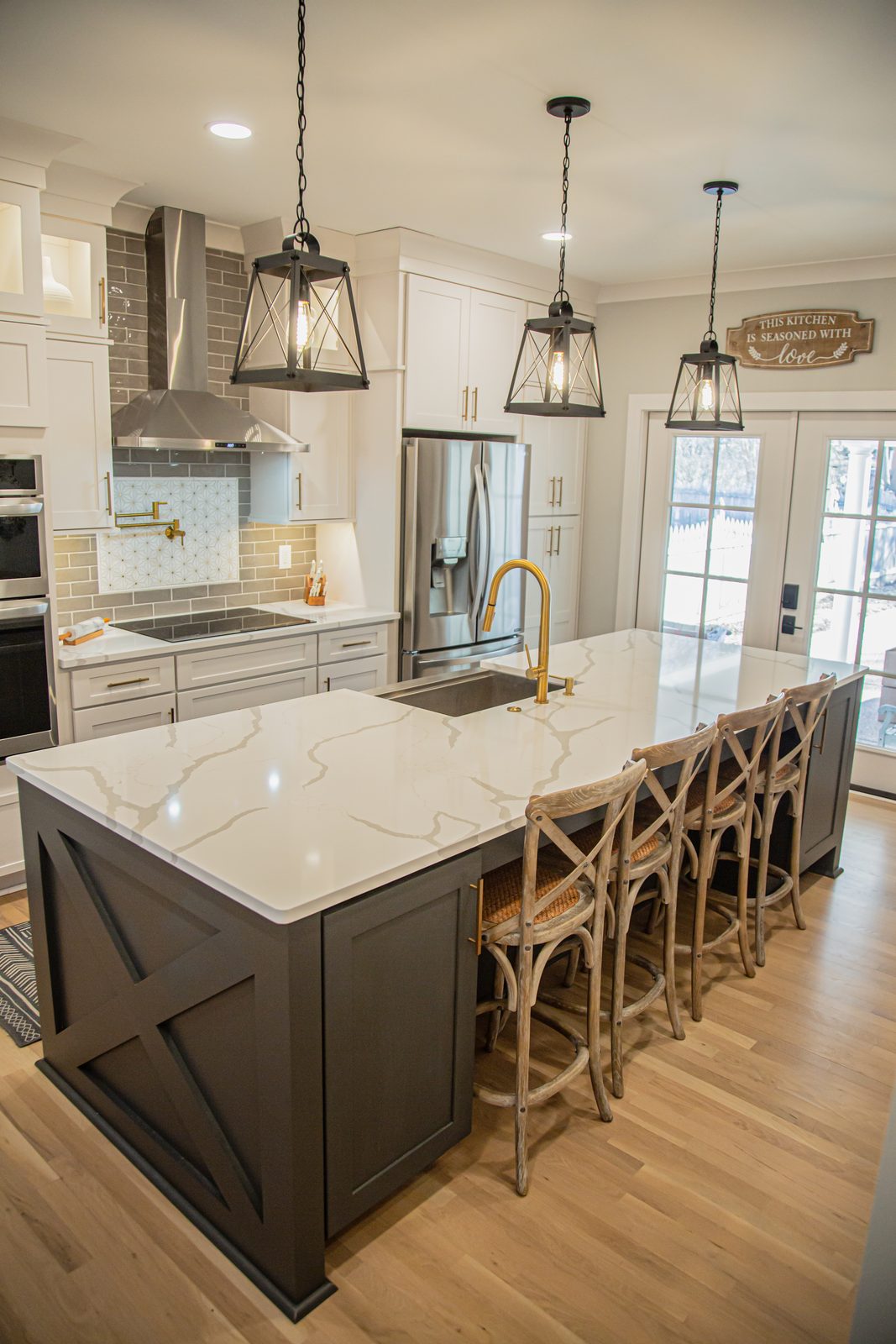 Open-concept kitchen with marble waterfall island
