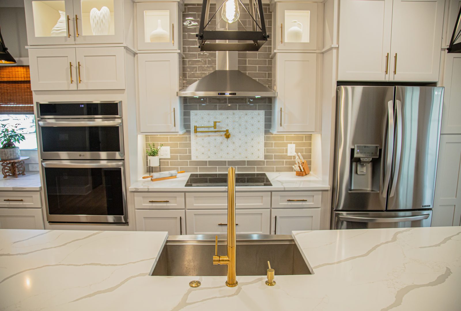 Custom kitchen with marble countertops and brass fixtures