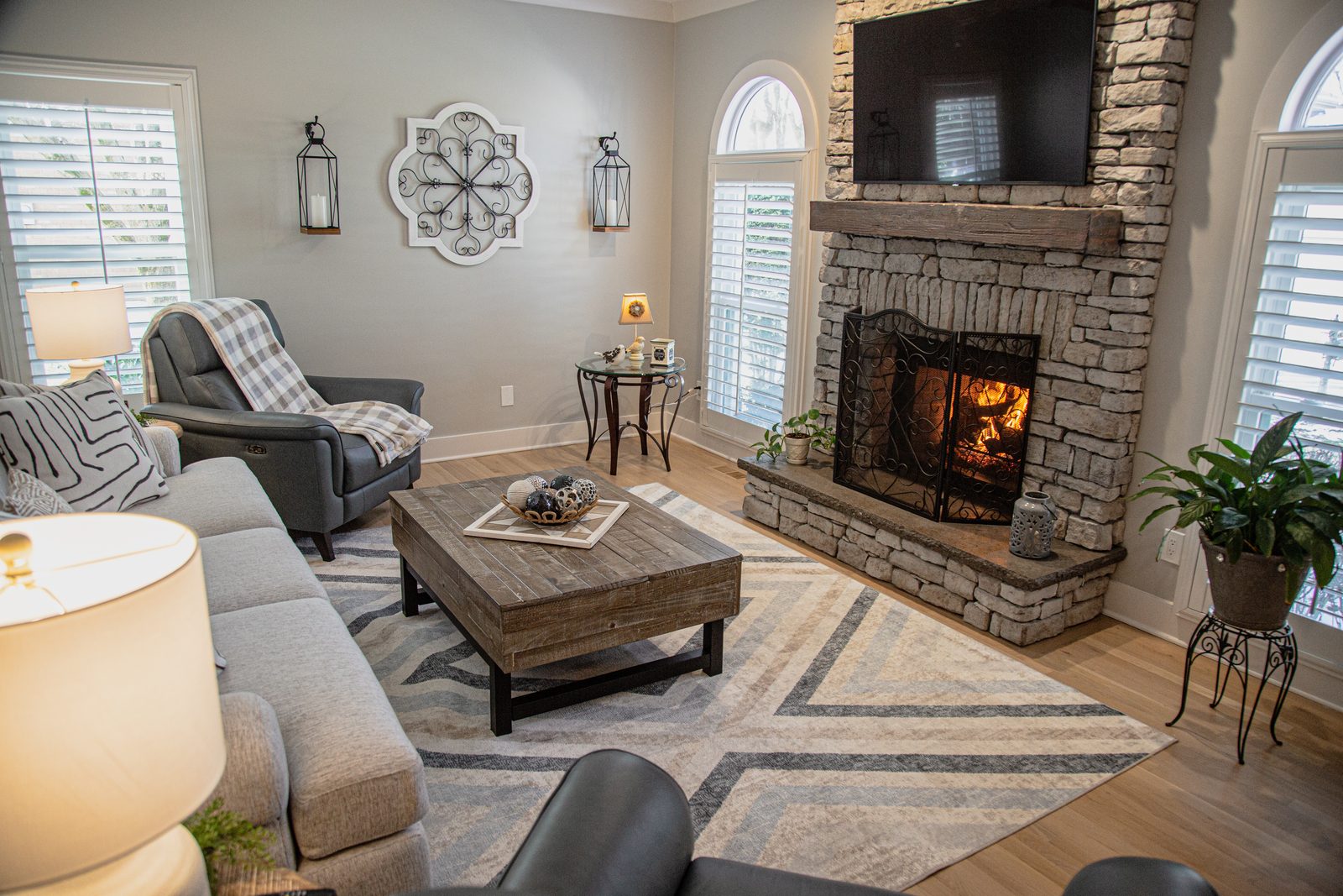 Living room with stone fireplace and vaulted ceiling