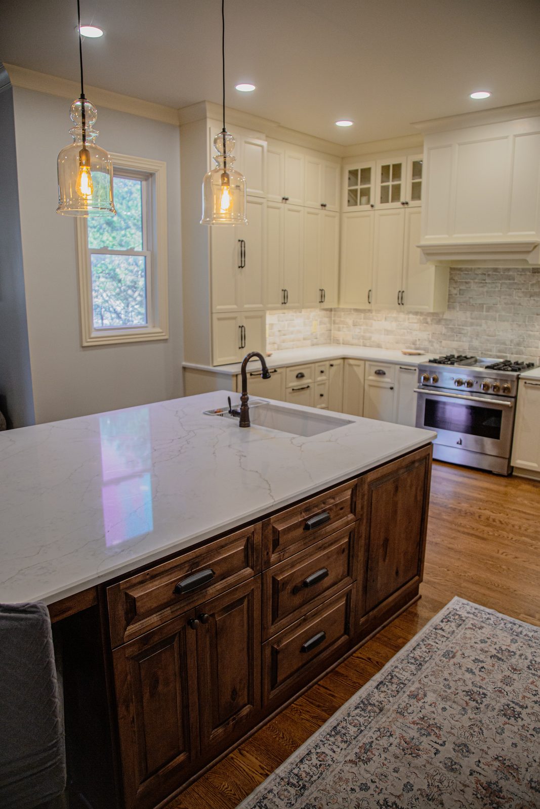 Classic white kitchen with walnut island